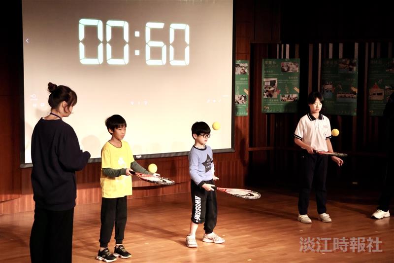 網球社成員教導學童如何顛球，並挑戰一分鐘內連續顛球。（攝影／李而義）