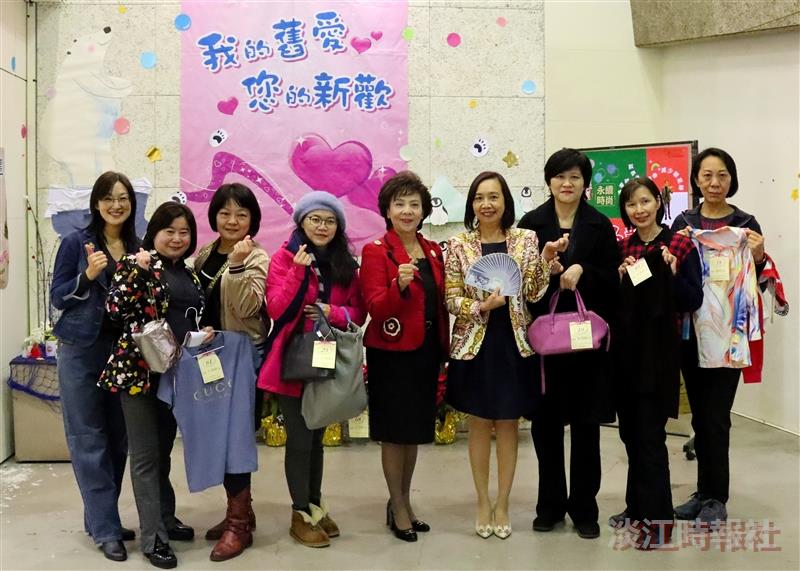 The Women's Association holds a secondhand clothing charity sale. Chairperson Flora Chia-I Chang (fifth from the left) poses for a photo with colleagues who successfully bid on items and are leaving with their purchases.