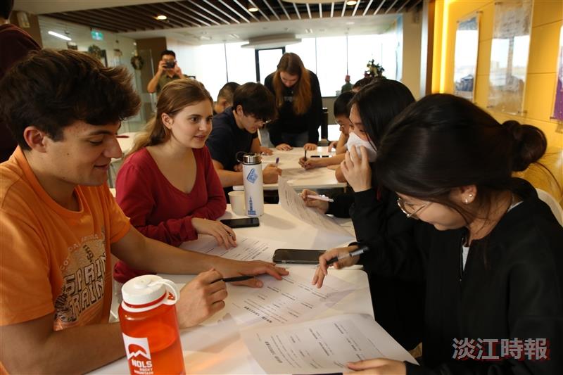 Local students and American high school students engaged in group discussions to exchange perspectives on cultural differences.
