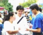 一位新生的母親在參加座談之後，與兒子一起逛海報街，並認真的聽取社團同學的簡介。（記者陳竹偉攝）