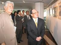 創辦人張建邦（圖右）聽取文錙藝術中心主任李奇茂（左）解說展出的藝術品。（攝影/陳國良）