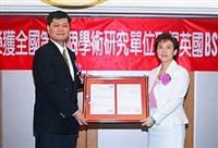 英國標準協會台灣分公司總經理高毅民親自頒發BS7799資訊安全證書給本校，由校長張家宜歡喜領證。（馮文星攝影）