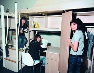 Female students are seen trying on the new beds that will be installed in the dormitory next semester.