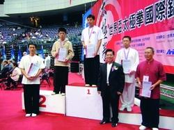 Chinese major sophomore Ling-gang Su (left) has won the second prize in Shadow Boxing World Cup. He is triumphantly receiving his award on the platform.
