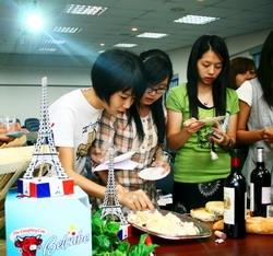 Students are seen tasting the cheese during the wine and cheese tasting event.