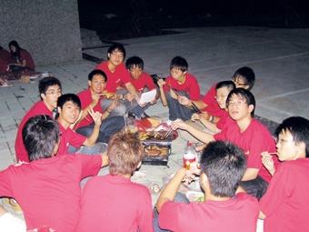 蘭陽新生們穿著學校發給的紅色制服，在涼涼秋風中享受烤肉的樂趣。（蘭陽校園提供）